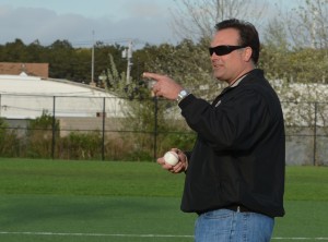 Sachem AD Gary Beutel throws out the first pitch.