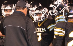 Malik Pierre, center of photo, scored three touchdowns for Sachem.